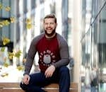 Man Sitting on Brown Wooden Bench