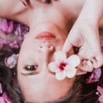 Photo of Woman Holding Pink Flower